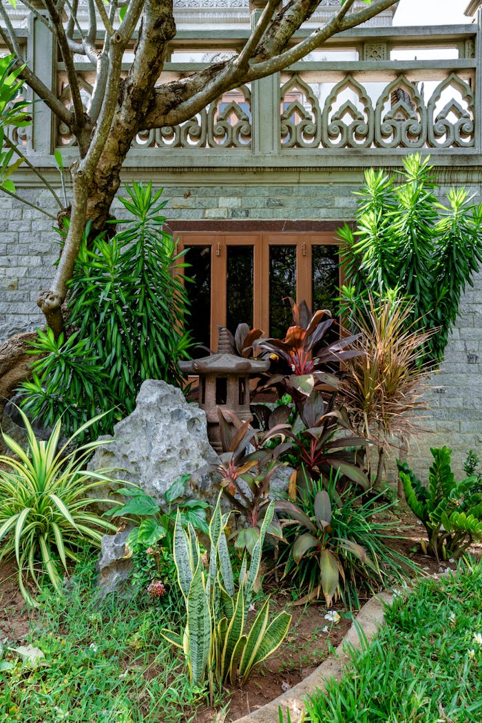 Home Vibrant garden with diverse plants and intricate stone railing.